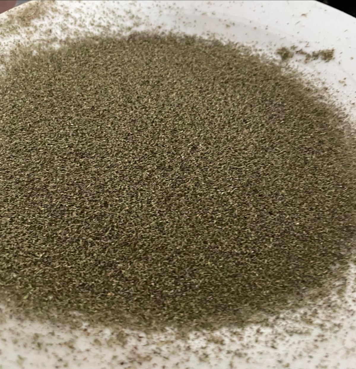 cleaning a brown shopping bag of catnip for seed, image 5 of 8