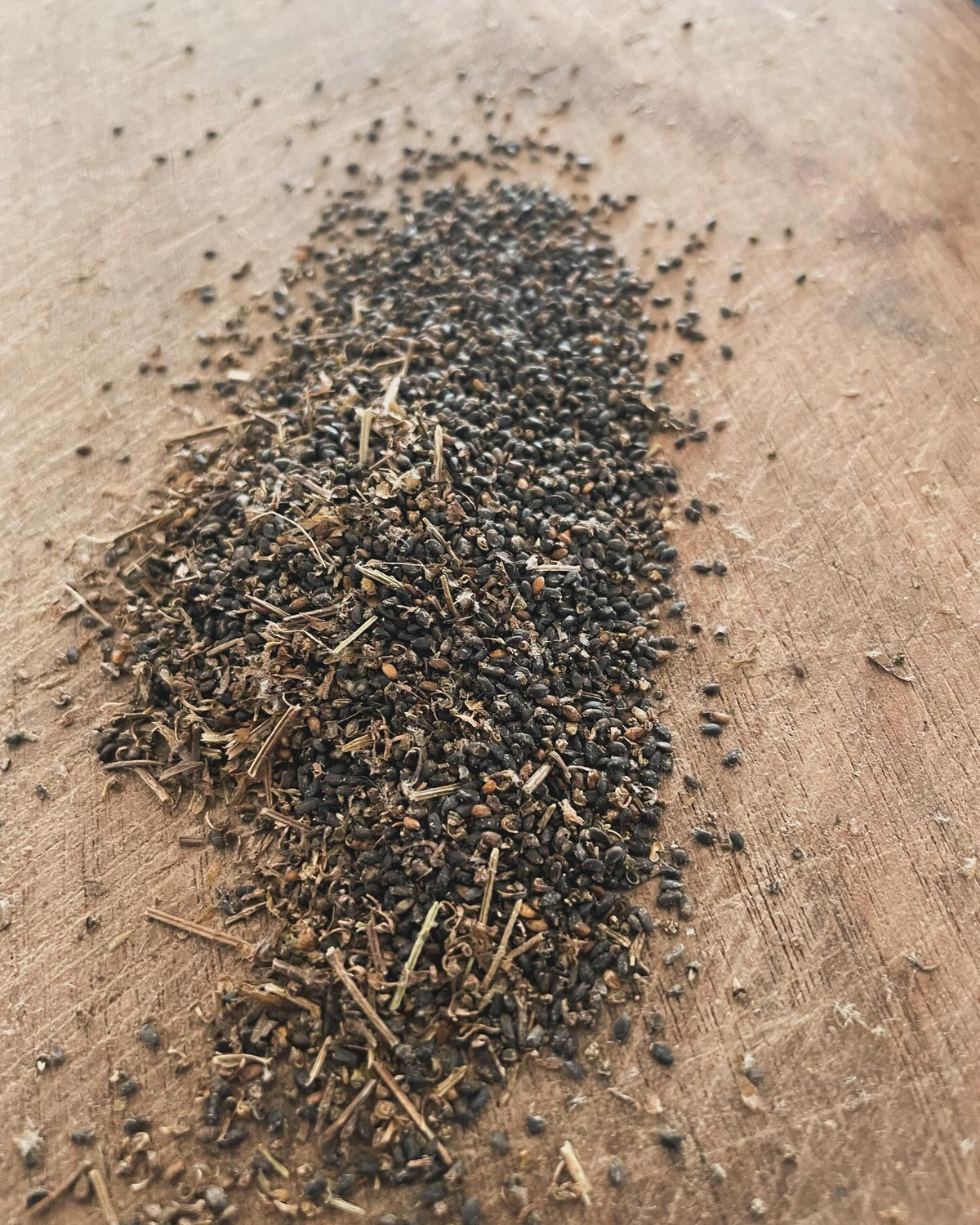 cleaning basil seed, I like to crush the flowers and then spread on a tilted cutting board, image 1 of 4