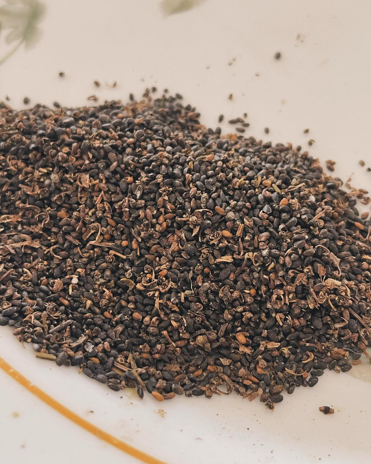 cleaning basil seed, I like to crush the flowers and then spread on a tilted cutting board, image 3 of 4