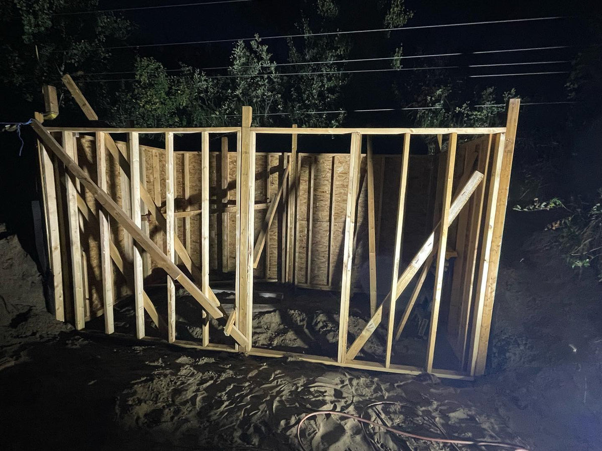 progress on the hillside root cellar, out framing after dark today, added some posts and framed the front wall, which